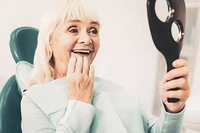 woman happy during her Southview Dental Care visit thanks to dental implants